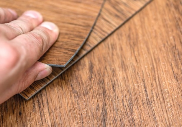 A person's hand holding a piece of wood AI-generated content may be incorrect.